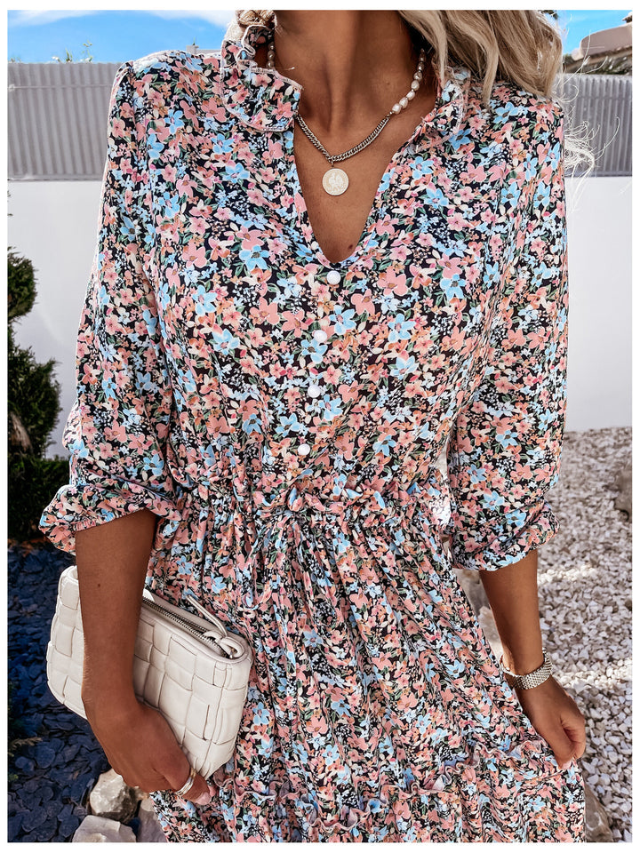Women's floral dress with playful ruffle details and knee-length cut