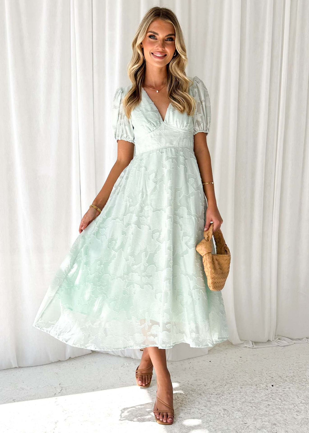 Women's maxi dress with floral accents and voluminous puff sleeves