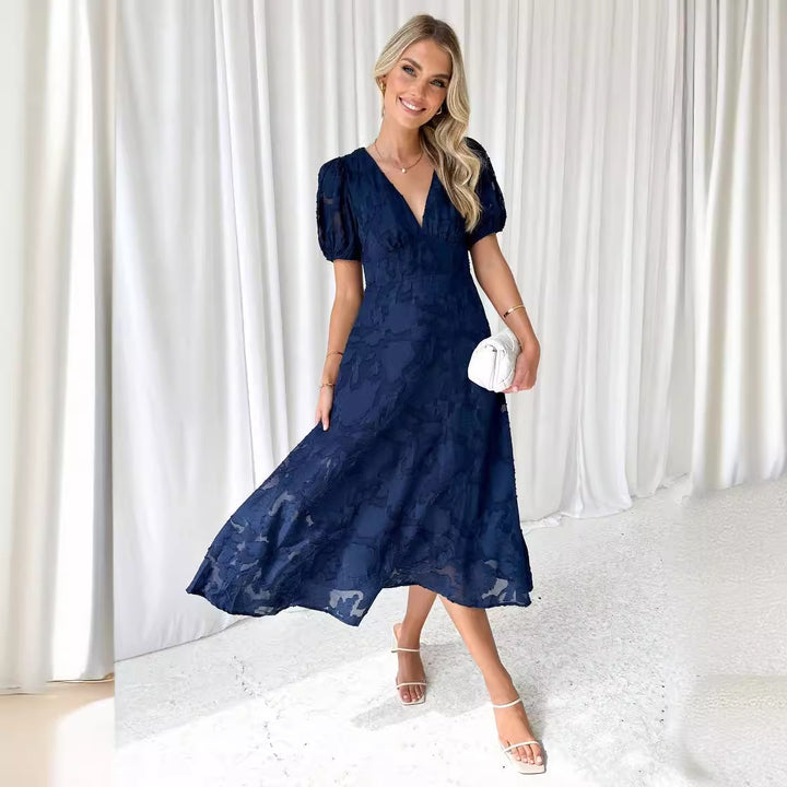 Women's maxi dress with floral accents and voluminous puff sleeves