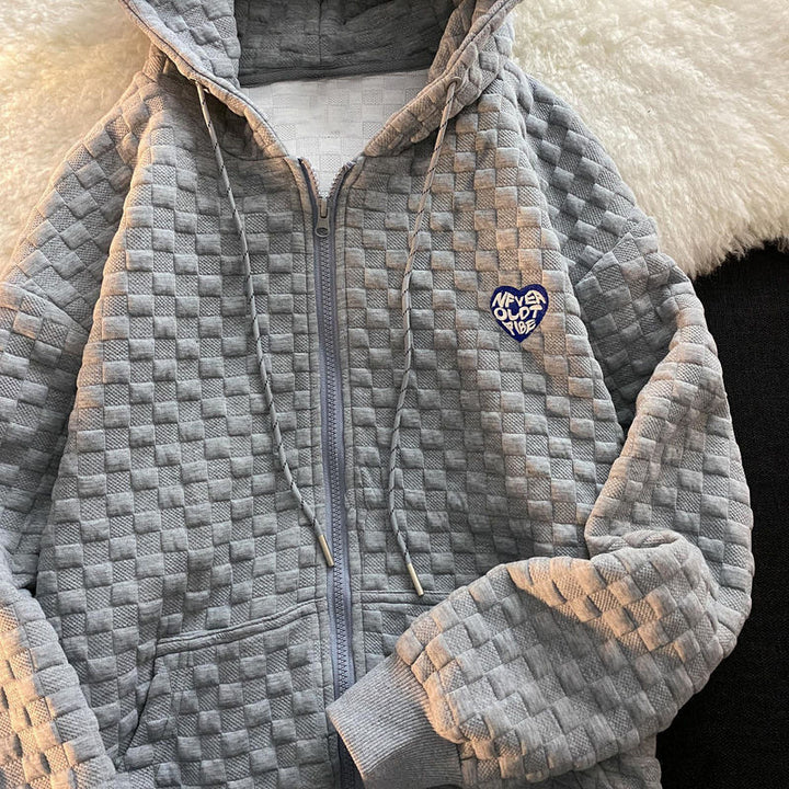 Women's hoodie jacket made of structured material with practical pockets and fashionable design