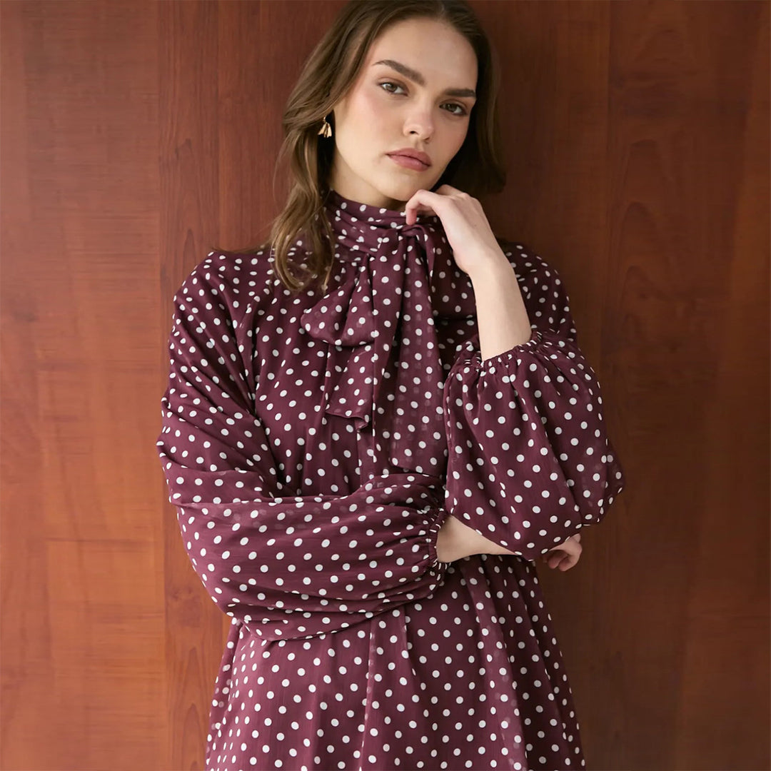 Women’s dress with elegant stand-up collar and playful polka dot design