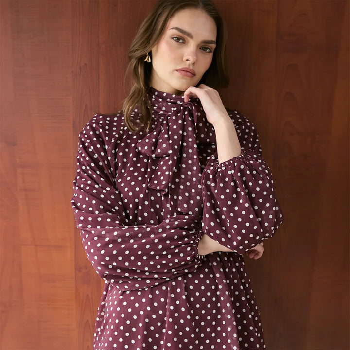 Women’s dress with elegant stand-up collar and playful polka dot design