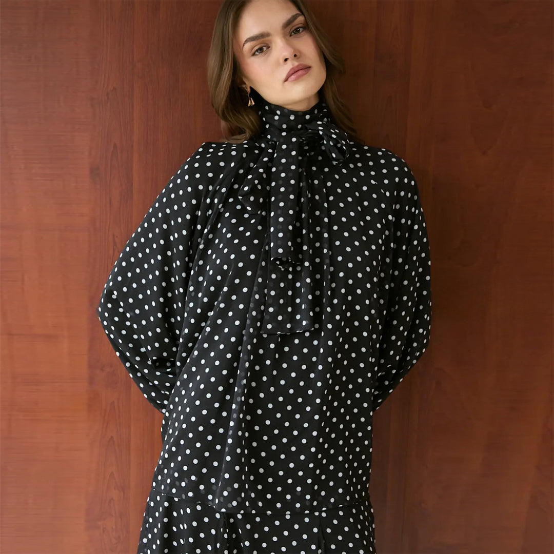 Women’s dress with elegant stand-up collar and playful polka dot design