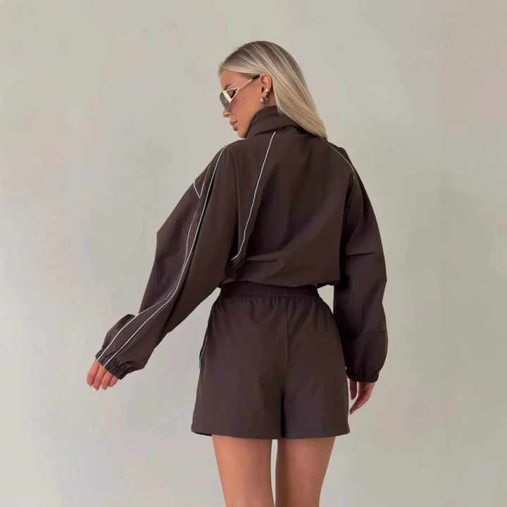 Women's sporty set consisting of a jacket with a high collar and shorts in urban style