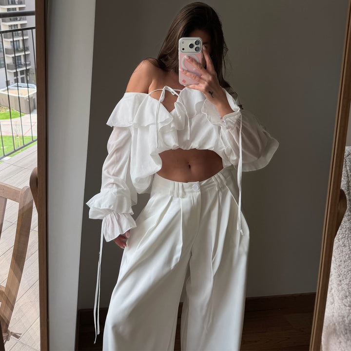 Women's blouse with voluminous ruffle details and captain sleeves